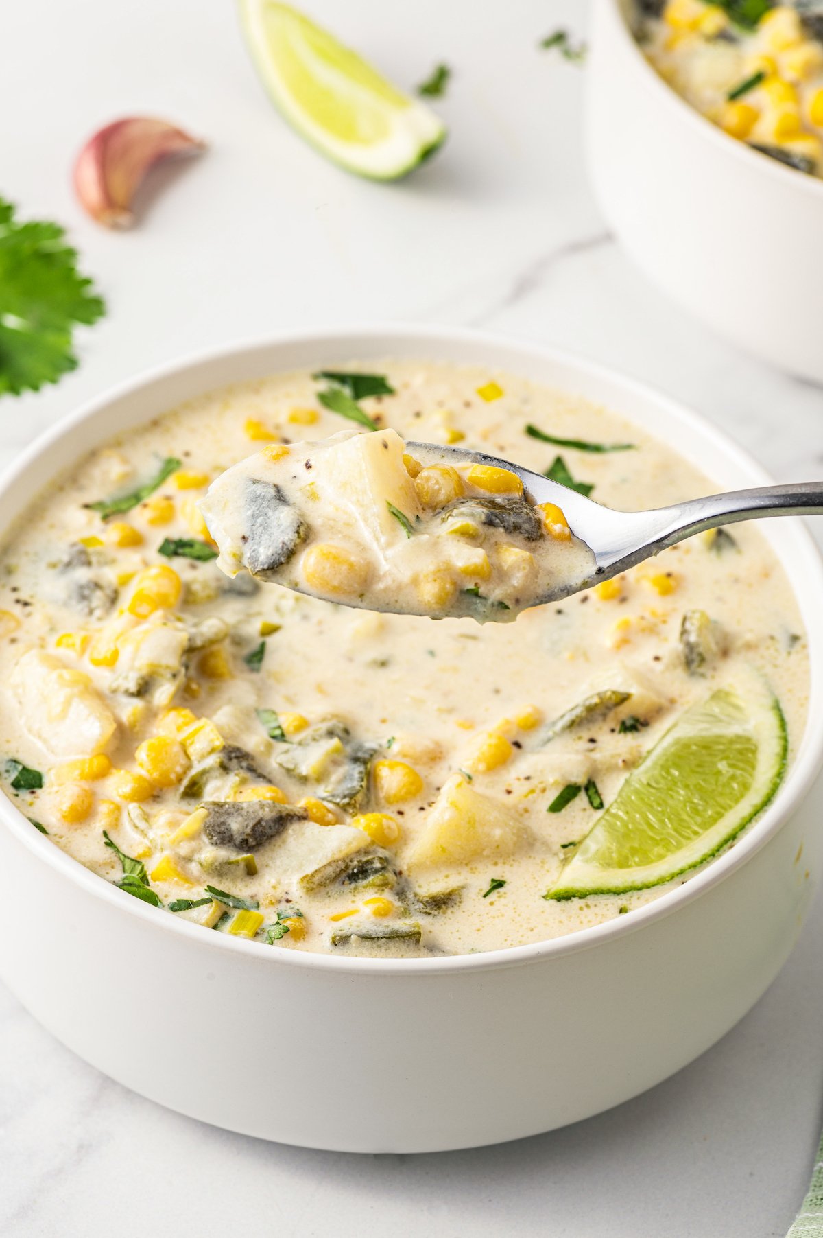 Close-up of spoonful of poblano corn soup. 