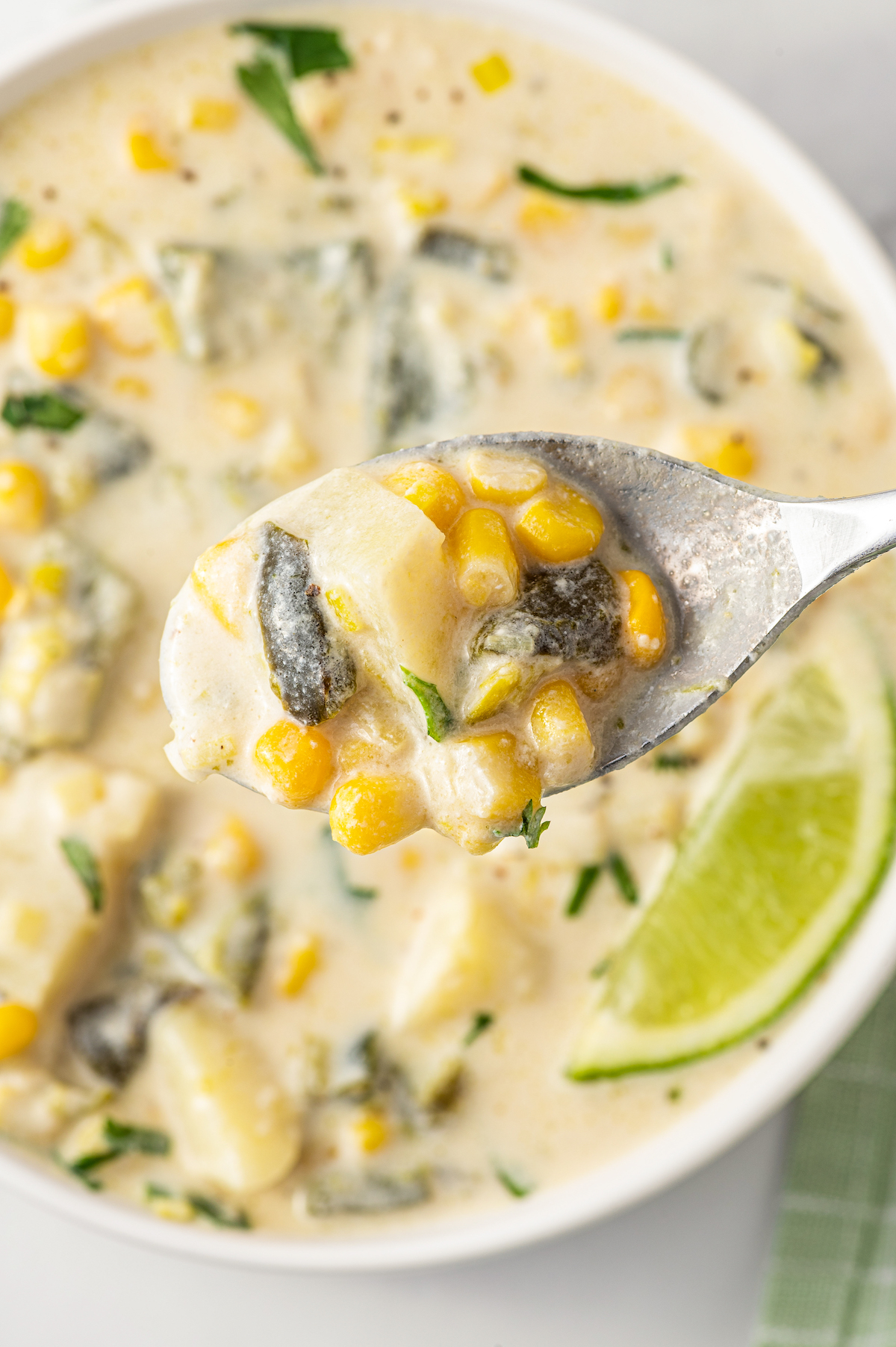 Spoonful of chunky poblano corn soup. 