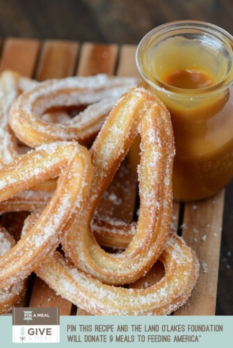 Churros with Salted Caramel Sauce on a wooden board