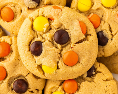 Reese's Pieces cookies piled on top of each other on a plate.