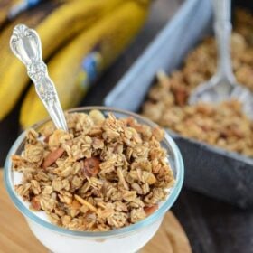 Banana Nut Granola served over yogurt in a glass dish with a spoon