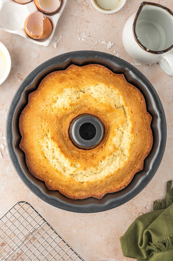 A baked bundt cake, cooling in the pan.