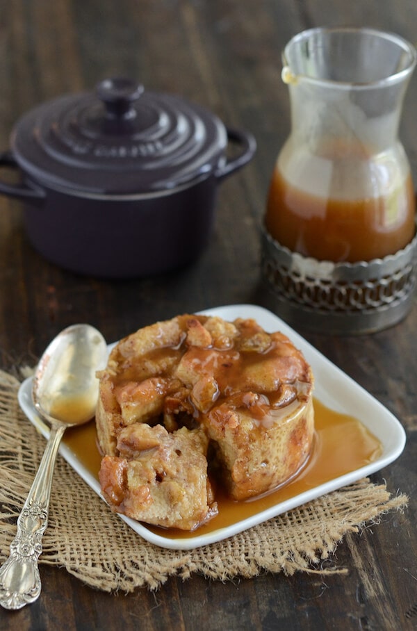A bite being taken out of donut bread pudding.