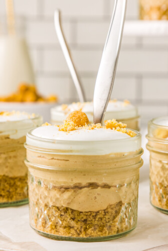 Mini mason jars filled with mini cheesecakes.