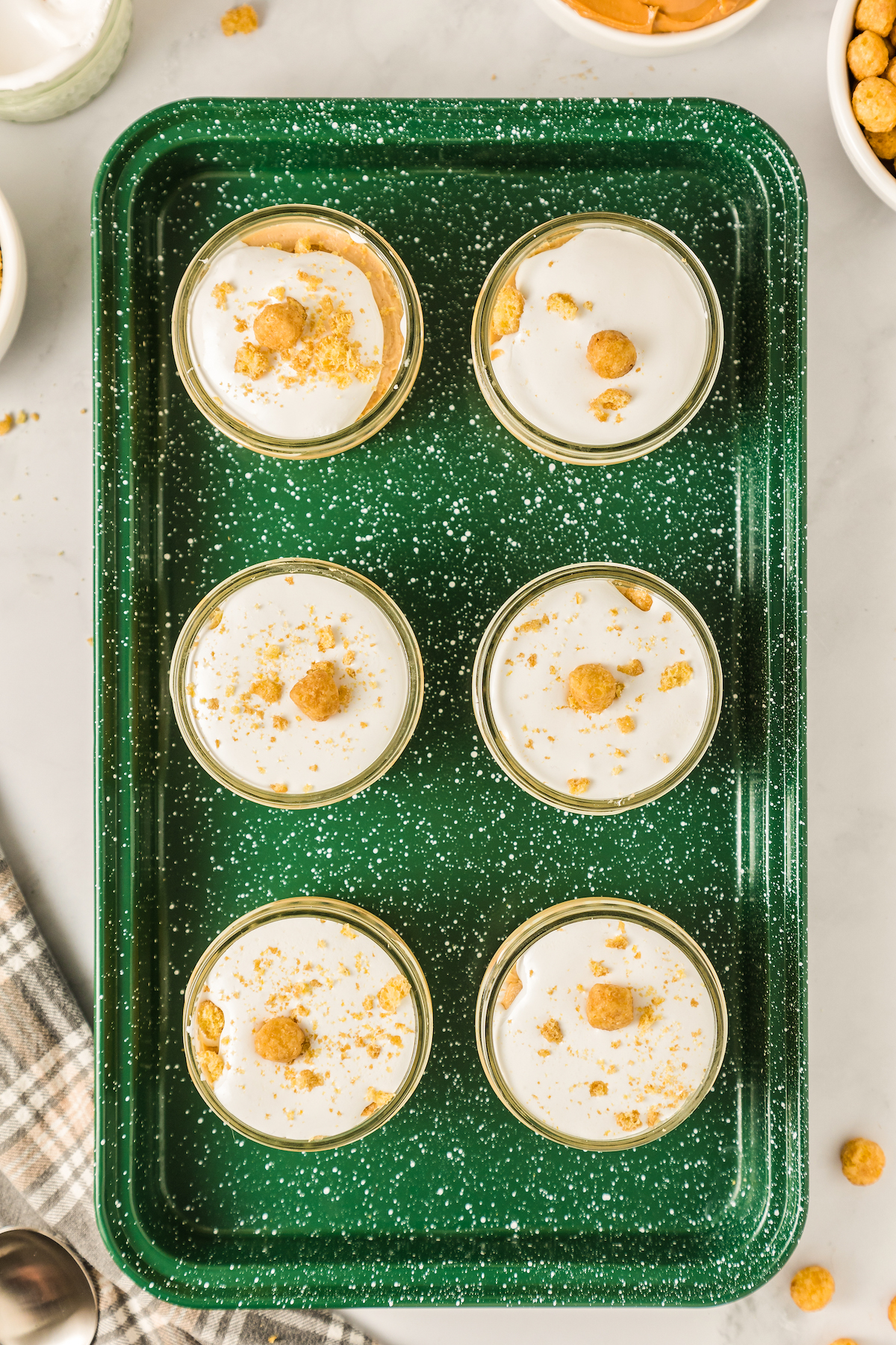 Overhead shot of mini cheesecakes on an enamel tray.