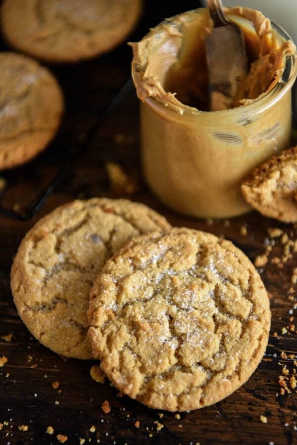 Soft Peanut Butter Cookies with sugar sprinkled on top next to a jar of peanut butter
