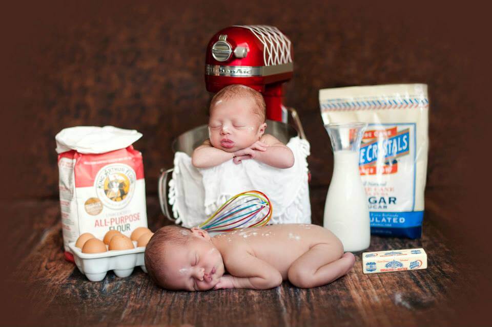 Two Newborn Babies Posed with Eggs, Milk, a Mixer and Other Kitchen Items
