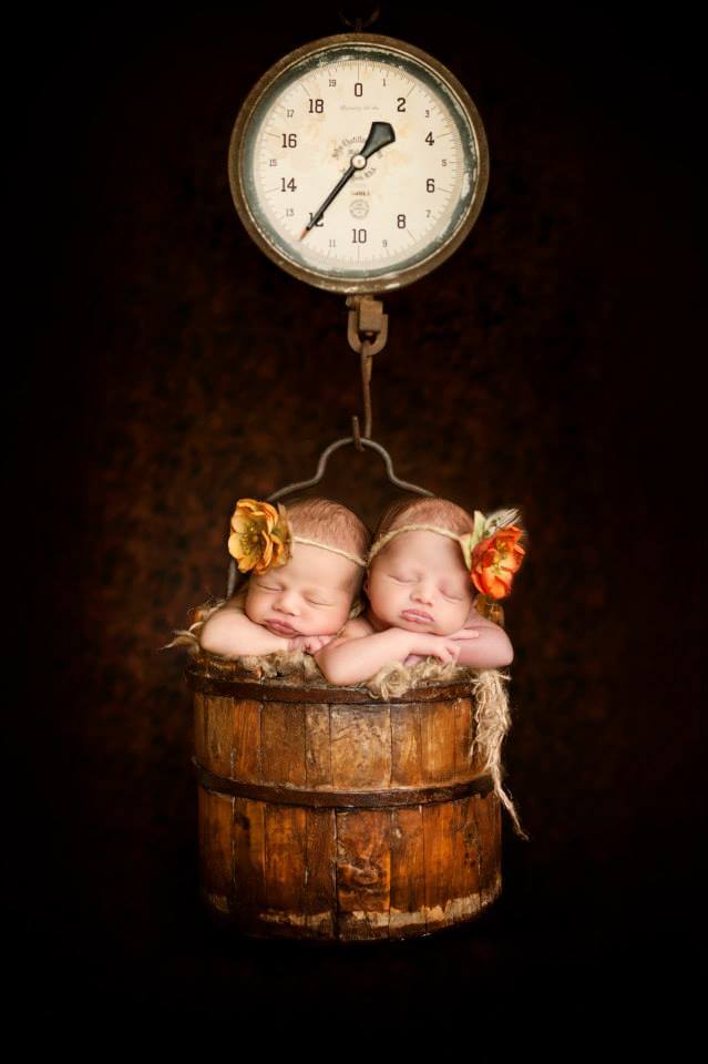 Two Newborns Sleeping in the Barrel of an Old Wooden Time Scale