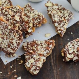 Pieces of Almond Toffee Candy Scattered on a Wooden Surface