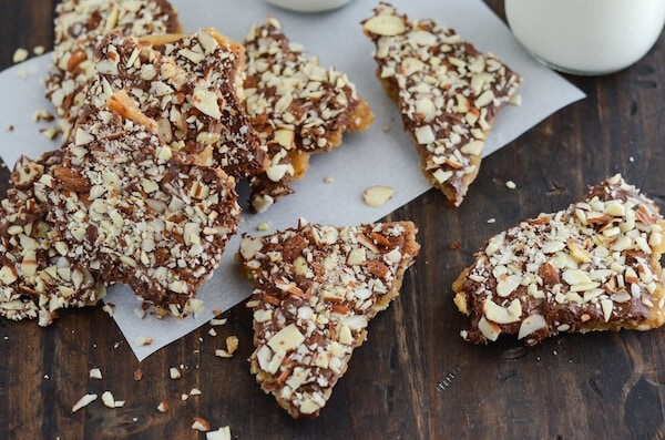 Pieces of Almond Toffee Candy Scattered on a Wooden Surface