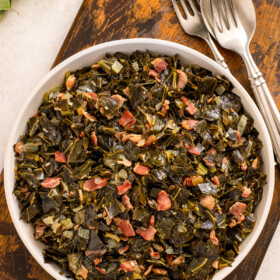 Beer-simmered, garlicky collard greens with smokey bacon in a big bowl.