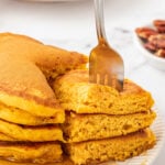 a fork getting a bite of pancakes