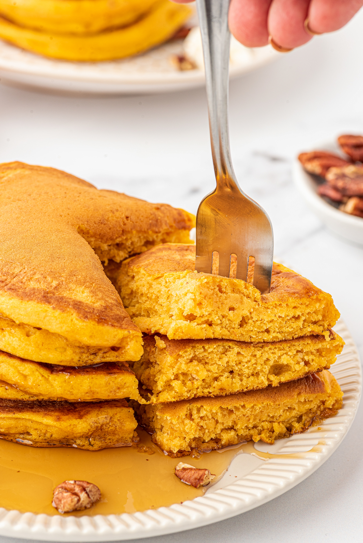 a fork getting a bite of pancakes