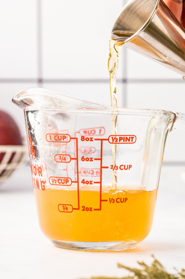 Mixing cocktail ingredients in a measuring cup.