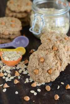 Oatmeal Scotchies with butterscotch chips and measuring spoons with oats