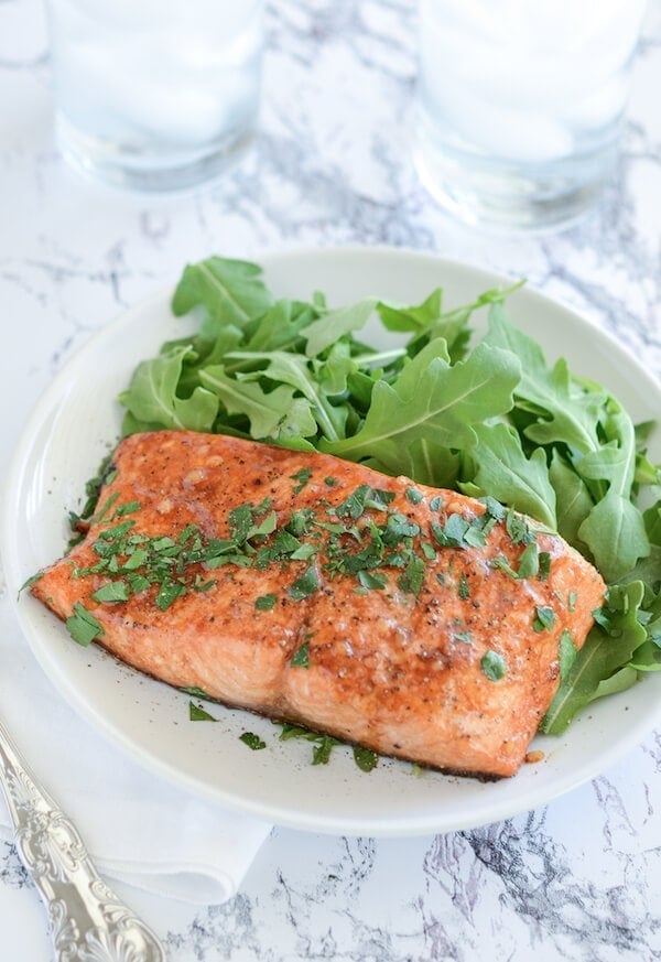 Balsamic Roasted Salmon on a white plate with a fork