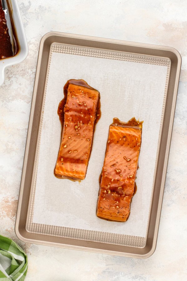 Balsamic glazed salmon filets on a baking sheet.