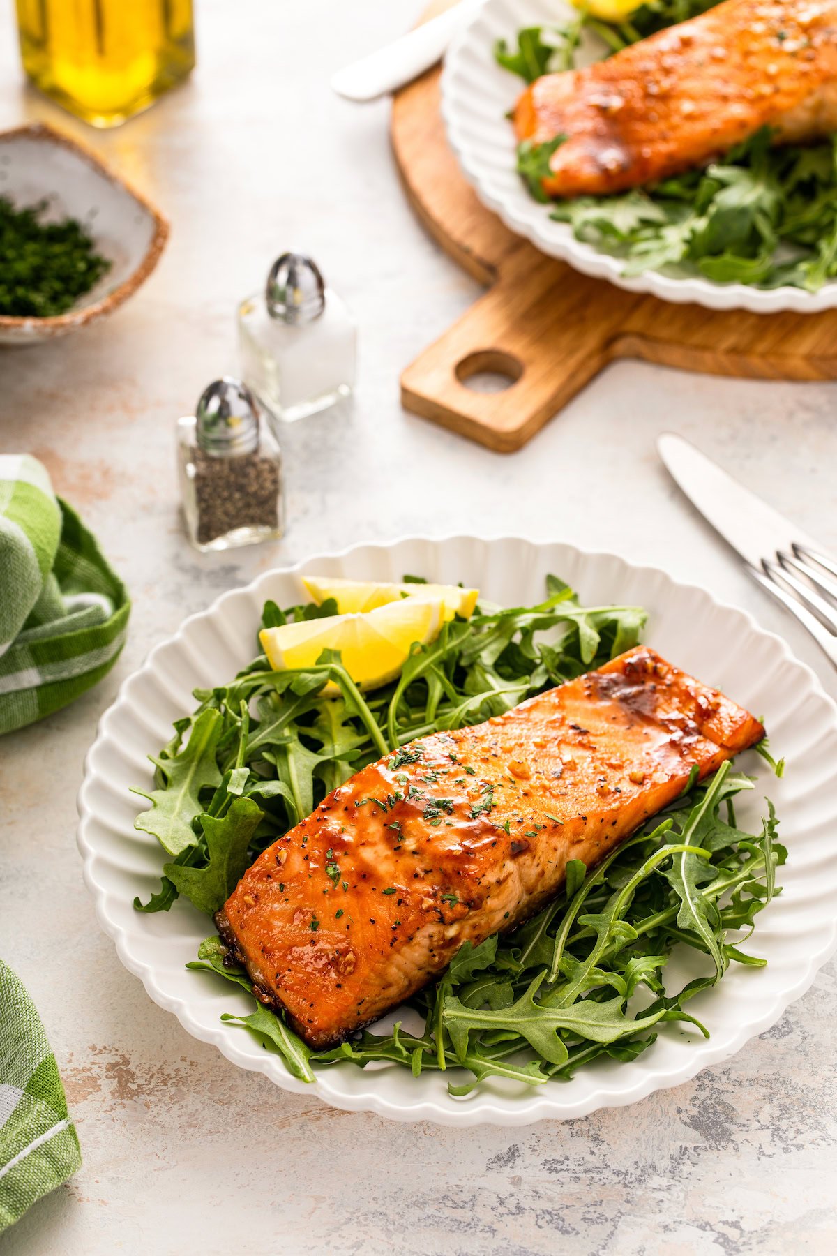 Juicy, balsamic salmon with fresh salad and lemon wedges on the side.