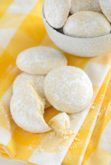 Lemon Cooler Cookies on a yellow and white cloth and in a white bowl