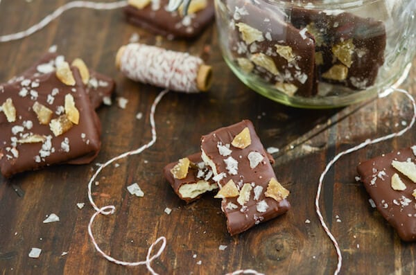 Chocolate covered Sea Salt and Crystallized Ginger Chocolate Wafers on a wooden surface with red and white string