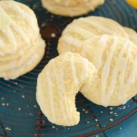 Lemon Cookies with Lemon Drizzle Icing on Top of a Wire Rack on a Table