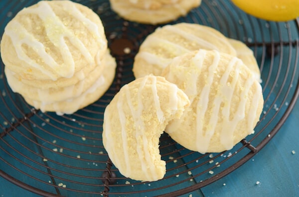 Lemon Cookies with Lemon Drizzle Icing on Top of a Wire Rack on a Table