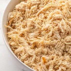 Shredded chicken in a large bowl.