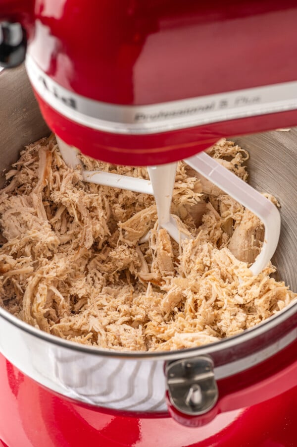 Using a stand mixer to shred chicken.