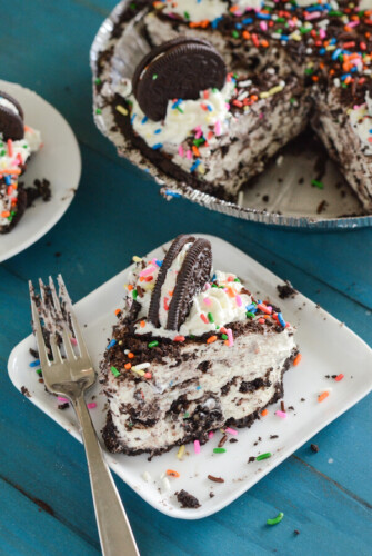 Yum! This slice of no bake cheesecake is filled and topped with Oreos and creamy birthday cake batter.