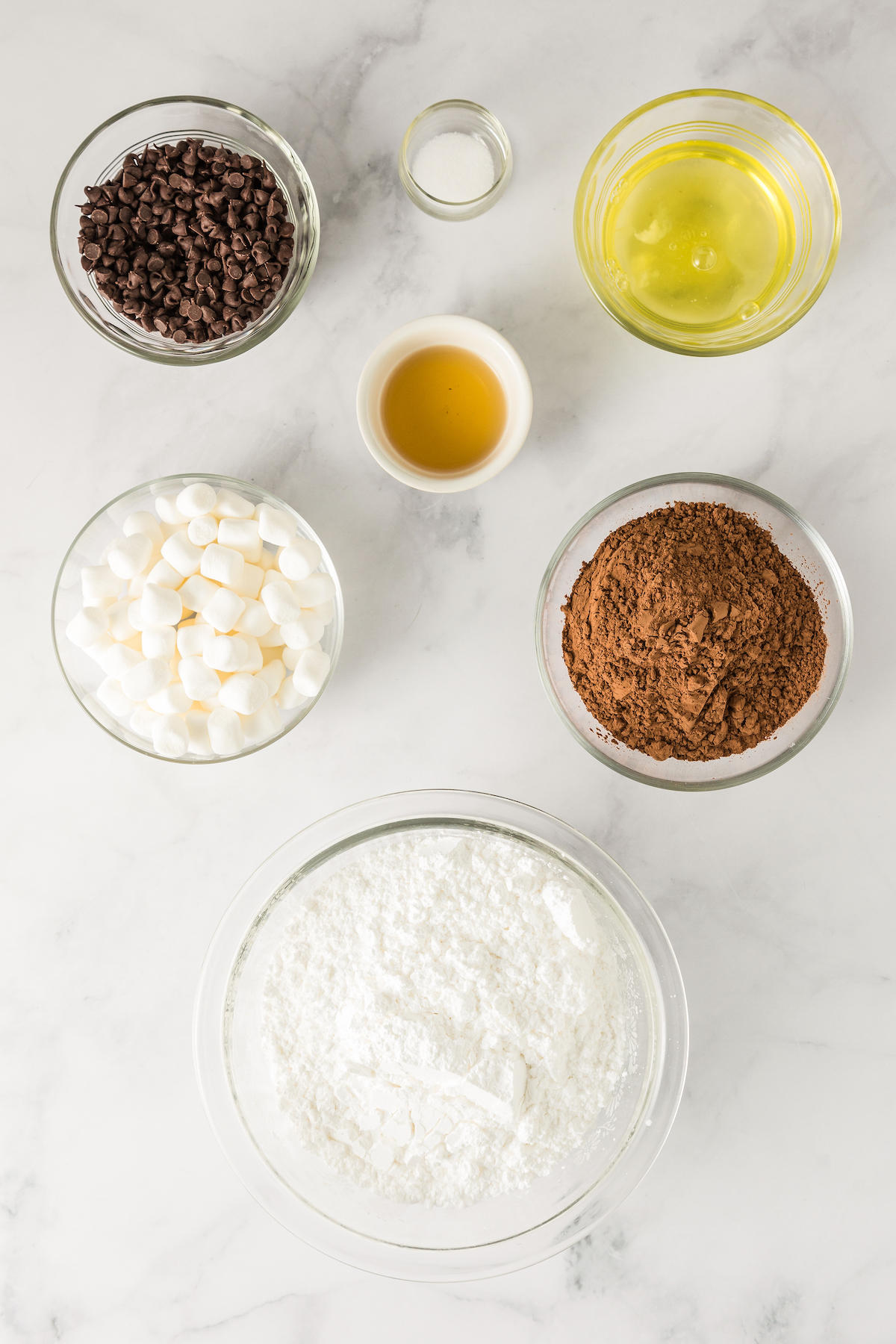 Ingredients for chocolate marshmallow cookies arranged on a work surface.