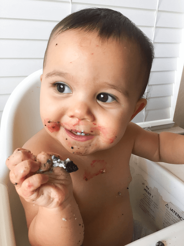 A Little Girl with Oreo Crumbs and Jelly From A Donut All Over Her
