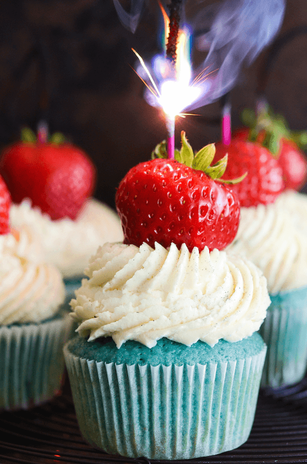 Red, White & Blue 4th of July Sparkler Cupcakes topped with whole strawberry and a sparkler