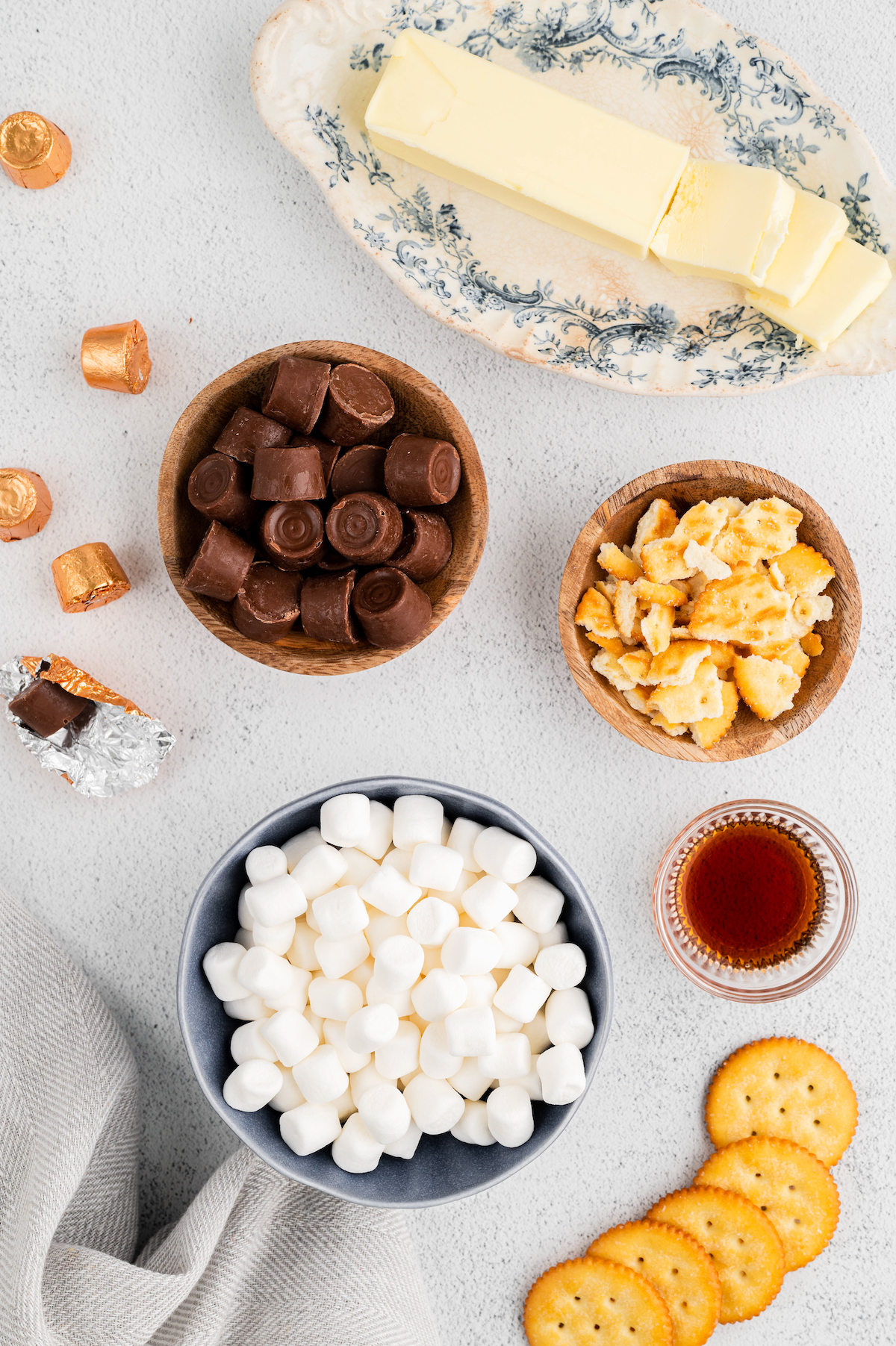 From top left: Rolo candies, butter, crushed and broken Ritz crackers, mini marshmallows, vanilla extract.
