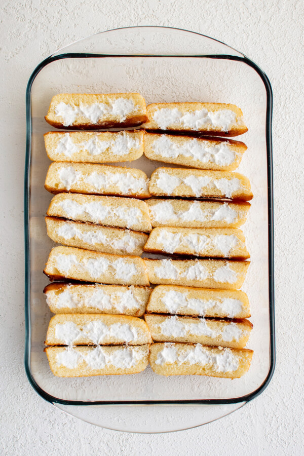 A glass baking dish lined with sliced Twinkies.