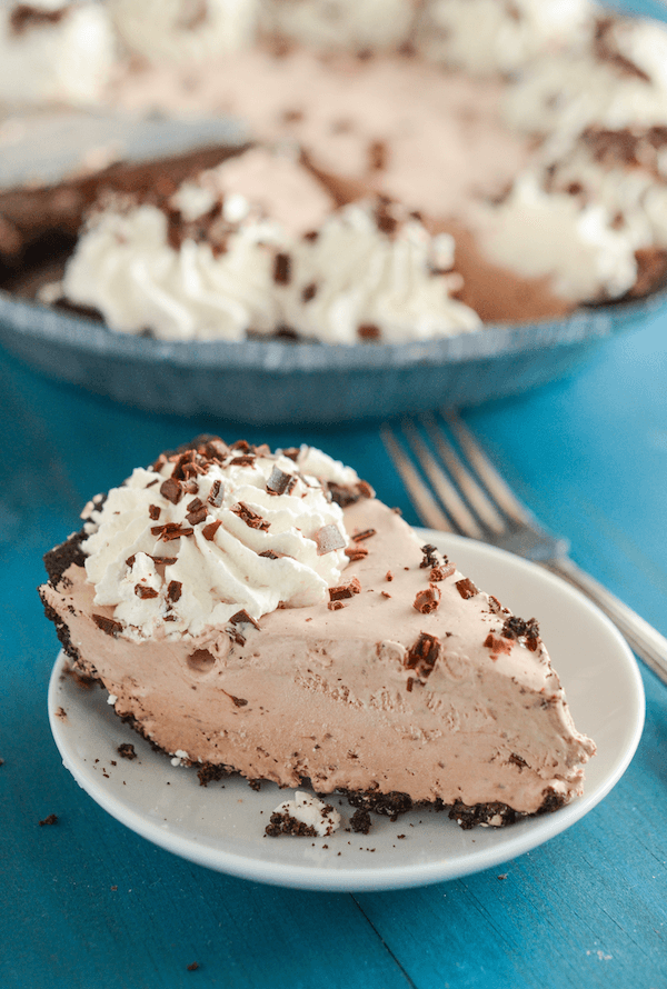 A Plate Holding a Slice of No-Bake Mocha Pie on a Blue Picnic Table