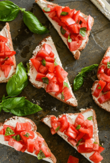 Tomato & Goat Cheese Toasts on a dark surface