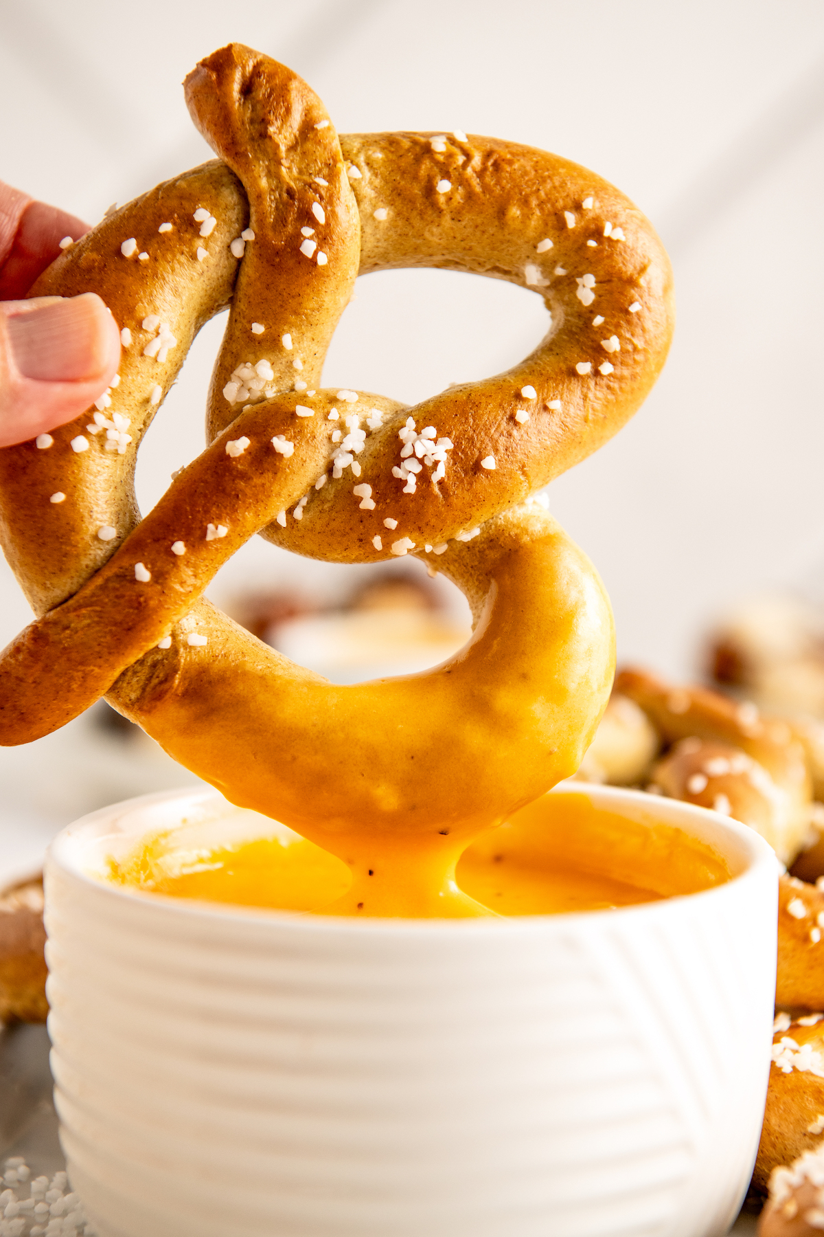 Dipping a pretzel into the beer cheese recipe. 
