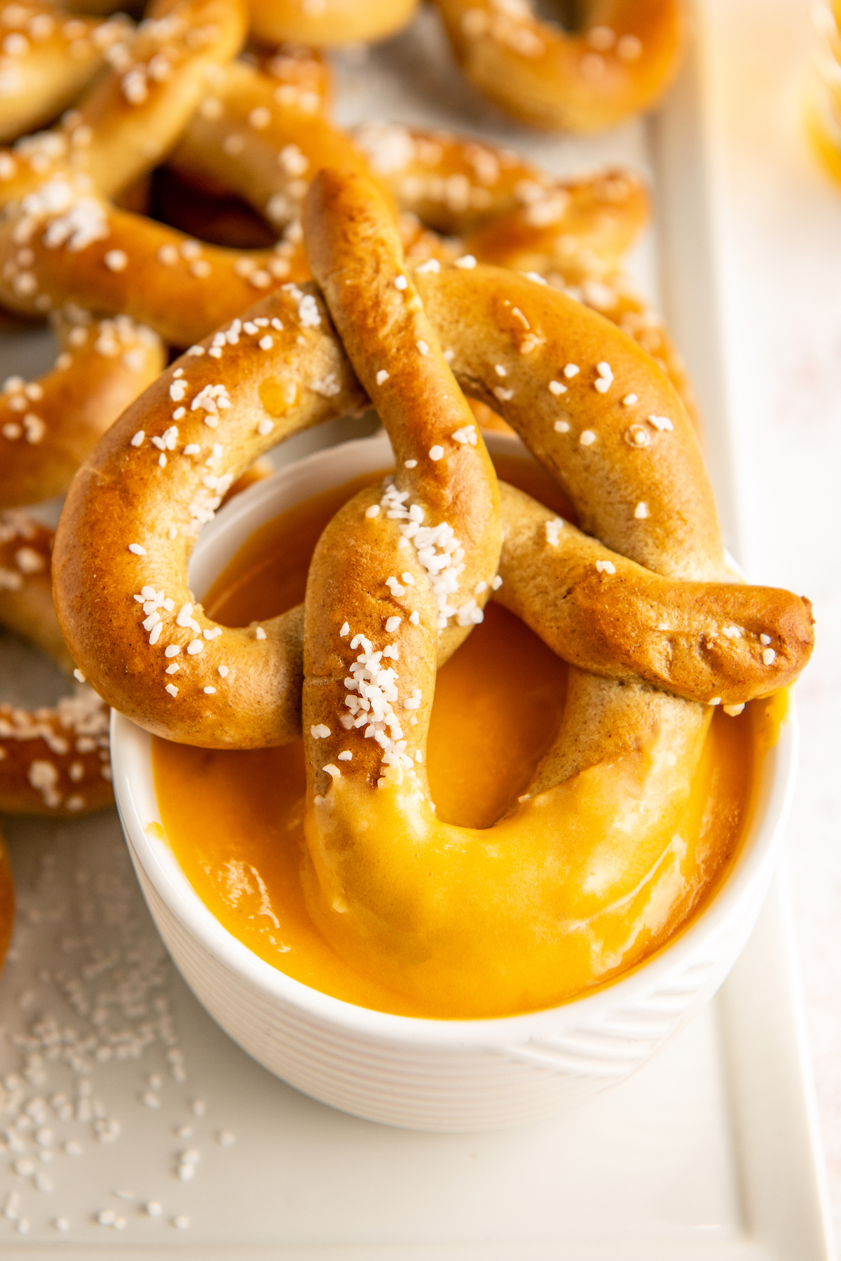 Pretzel dipped into the cheese dip. 