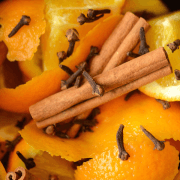 Cinnamon Orange Potpourri in a slow cooker crock with cloves, cinnamon sticks, and oranges.