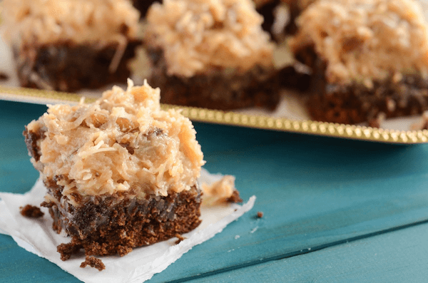 A Fudgy Chocolate Brownie with Coconut Frosting on a Teal Tablecloth