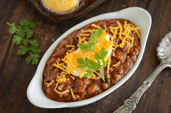 Slow Cooker Bean Chili and Easy Cornbread Muffins in an oval casserole dish