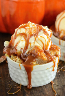 Caramel Apple Dump Cake in a jar with ice cream and caramel on top.