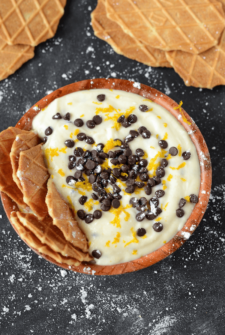 Chocolate Orange Cannoli Dip with waffle cone chips topped with orange zest and chocolate chips
