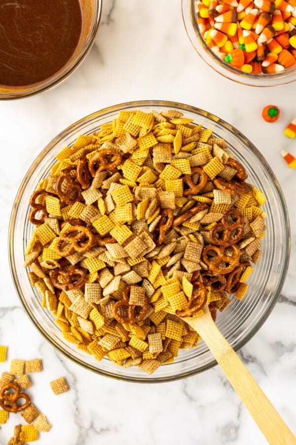 Chex snack mix stirred in a mixing bowl.