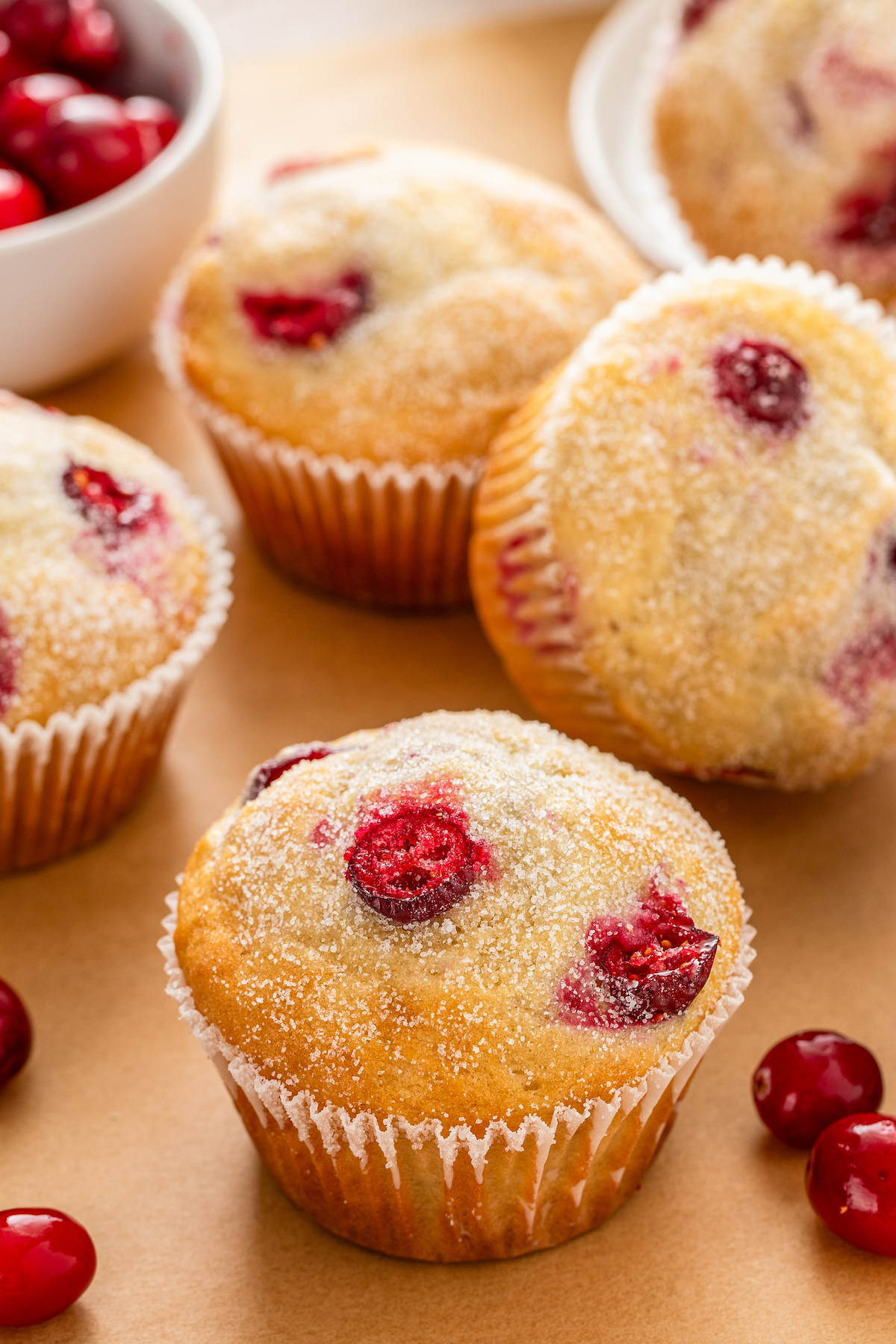 Fresh cranberry muffins with glistening sugar tops. 