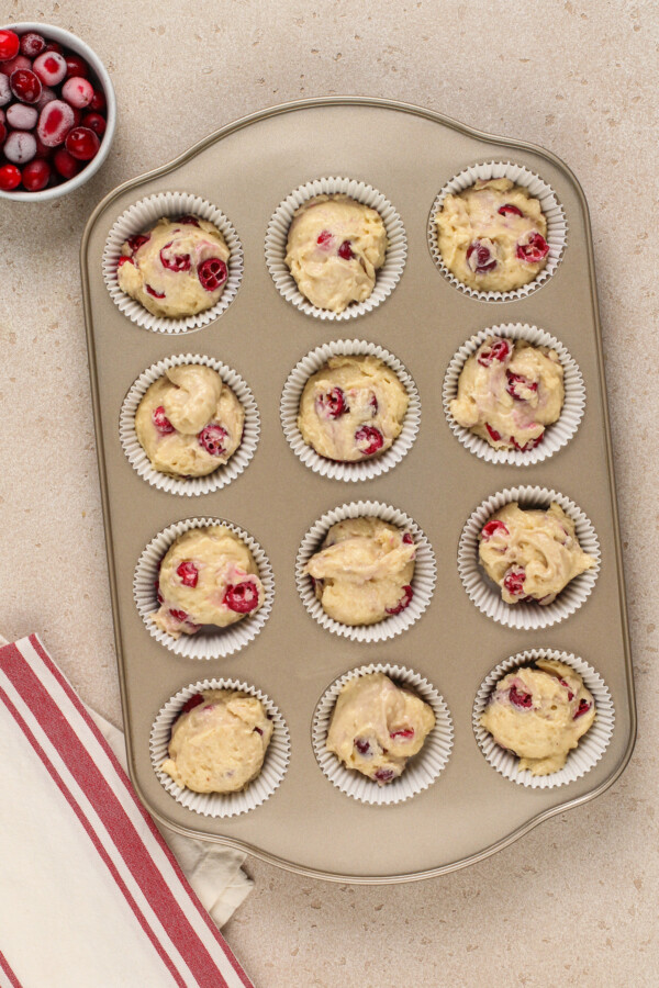 Filling the cupcake liners with muffin batter.