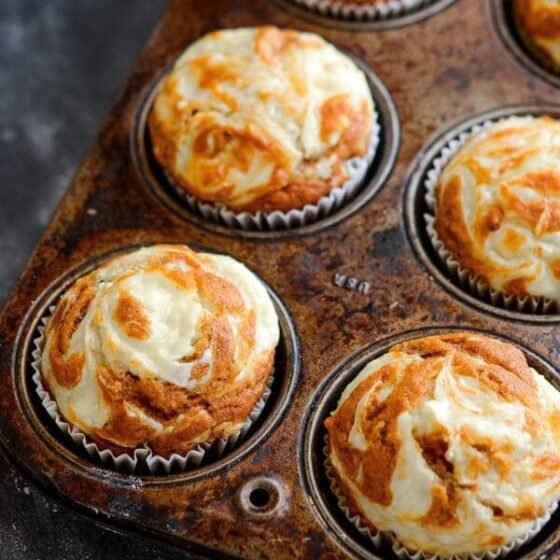 Pumpkin Cream Cheese Swirl Muffins: my favorite pumpkin muffins ever. You start with a moist spiced pumpkin muffin and top it with swirls of sweet cream cheese that melt into the top as it bakes. Bonus? They only take 30 minutes to make!