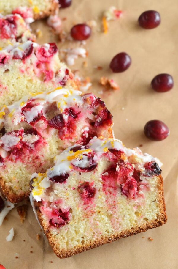 Cranberry Orange Bread drizzled with orange icing and orange zest.