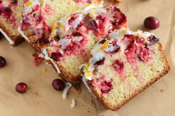 Slices of glazed cranberry orange bread.