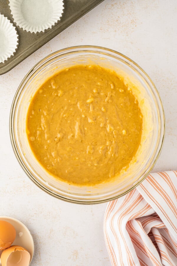 Banana muffin batter in a mixing bowl.